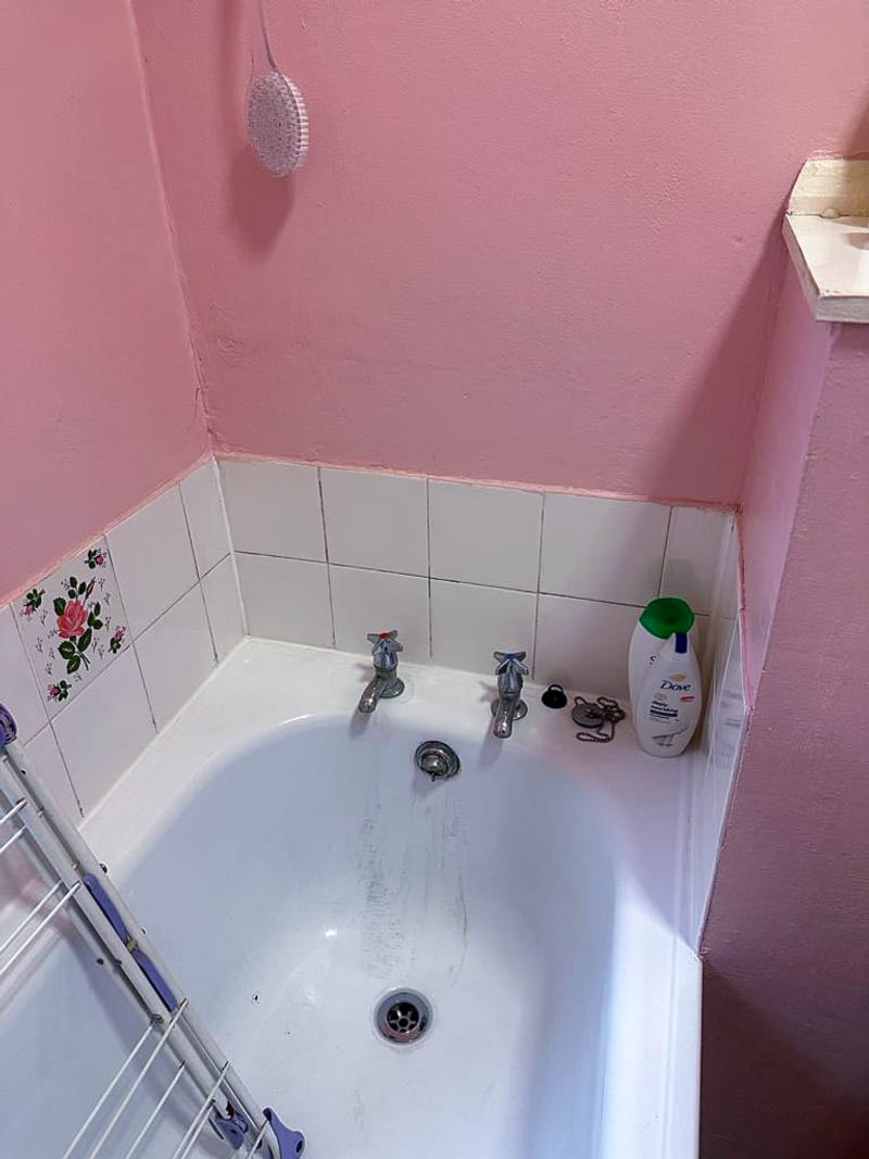 The same bathroom, the wall above the bath, before the works